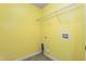 Bright laundry room with yellow walls and a wire rack for storage at 223 Triumph Dr, Elon, NC 27244