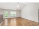 Spacious living room with hardwood floors, a vaulted ceiling, and ample natural light perfect for gatherings at 223 Triumph Dr, Elon, NC 27244