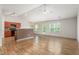 Open-concept living area with hardwood floors, vaulted ceilings, and seamless transition to the adjacent kitchen at 223 Triumph Dr, Elon, NC 27244