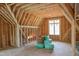 Unfinished attic showcasing framing, window, and flooring, ready for customization at 2328 Ballywater Lea Way, Wake Forest, NC 27587