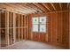 Framed bedroom featuring unfinished walls, window, and electrical wiring for personalization at 2328 Ballywater Lea Way, Wake Forest, NC 27587