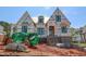 Two-story home under construction, featuring brick base, windows, and a partially installed roof at 2328 Ballywater Lea Way, Wake Forest, NC 27587