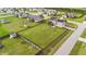 Aerial view of a home with a large, fenced backyard featuring lush green lawn and mature trees at 24 Kaki Ct, Selma, NC 27576
