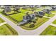 Two-story home with a two car garage, lush lawn, and mature landscaping in a suburban neighborhood at 24 Kaki Ct, Selma, NC 27576