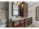 Bathroom with dark wood vanity, lots of drawer space, and a large mirror above the sink at 24 Kaki Ct, Selma, NC 27576