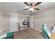 Neutral bedroom with a ceiling fan and closet, staged as a home office at 24 Kaki Ct, Selma, NC 27576