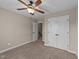 Neutral bedroom with a ceiling fan, closet, and access to another room at 24 Kaki Ct, Selma, NC 27576