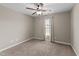 Empty bedroom featuring neutral paint, carpeting, and a window with curtains at 24 Kaki Ct, Selma, NC 27576