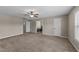 Spacious neutral bedroom with carpet floors, a ceiling fan and multiple doors at 24 Kaki Ct, Selma, NC 27576
