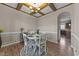 A dining room featuring a decorative wood ceiling, wood floors, and a round table with four chairs at 24 Kaki Ct, Selma, NC 27576