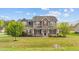 Charming two-story home features a covered front porch and well-manicured lawn, creating an inviting curb appeal at 24 Kaki Ct, Selma, NC 27576