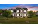 Charming two-story home features a covered front porch and well-manicured lawn, creating an inviting curb appeal at 24 Kaki Ct, Selma, NC 27576