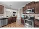 Well-equipped kitchen featuring stainless steel appliances, granite countertops, and ample cabinet space at 24 Kaki Ct, Selma, NC 27576