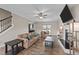 Bright living room features a cozy seating arrangement, a fireplace and wood-look flooring at 24 Kaki Ct, Selma, NC 27576