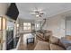 Bright living room features a cozy seating arrangement, a fireplace and wood-look flooring at 24 Kaki Ct, Selma, NC 27576