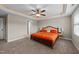 A large main bedroom featuring a decorative ceiling with a ceiling fan and two side tables with lamps at 24 Kaki Ct, Selma, NC 27576