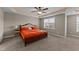 A large main bedroom featuring a decorative ceiling with a ceiling fan and a large window at 24 Kaki Ct, Selma, NC 27576