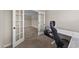 Light-filled office with glass paneled doors and a view to an adjacent room at 24 Kaki Ct, Selma, NC 27576
