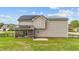 Back exterior view of home featuring a screened-in porch and solar panels at 24 Kaki Ct, Selma, NC 27576
