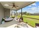 Inviting screened porch with ceiling fan and comfortable seating overlooking the yard at 24 Kaki Ct, Selma, NC 27576