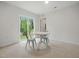 Cozy dining area with a table and chairs, showcasing natural light from sliding glass doors and neutral carpeting at 25 Beechnut Ct, Franklinton, NC 27525