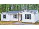 Charming single-story home featuring white siding, black shutters, and a welcoming front porch at 25 Beechnut Ct, Franklinton, NC 27525