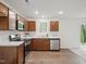 Modern kitchen with stainless steel appliances, solid surface countertops, and wood-look flooring at 25 Beechnut Ct, Franklinton, NC 27525