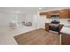 Cozy living space merging with a modern kitchen, showcasing wood flooring and natural light at 25 Beechnut Ct, Franklinton, NC 27525