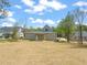 Expansive backyard featuring a gray two-story home with a partially-covered porch at 250 Pilot Ridge Rd, Zebulon, NC 27597