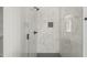 Modern bathroom shower featuring sleek white marble tile and stylish fixtures at 250 Pilot Ridge Rd, Zebulon, NC 27597