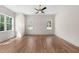 Spacious bedroom featuring hardwood floors, a ceiling fan, two large windows, and neutral paint at 250 Pilot Ridge Rd, Zebulon, NC 27597