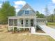 Charming two-story home with a welcoming front porch and well-manicured landscaping, offering curb appeal at 250 Pilot Ridge Rd, Zebulon, NC 27597