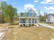 Charming two-story home with a covered porch, a screened porch, and well-manicured front yard at 250 Pilot Ridge Rd, Zebulon, NC 27597