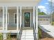 Inviting front door with sidelights and stairs leading to the covered porch, enhancing entry appeal at 250 Pilot Ridge Rd, Zebulon, NC 27597