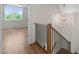 Hallway with wood staircase and light fixture, leading to a bright room at 250 Pilot Ridge Rd, Zebulon, NC 27597