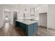 Modern kitchen featuring a large island, stainless steel appliances, and white cabinetry at 250 Pilot Ridge Rd, Zebulon, NC 27597