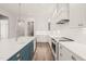 The stylish kitchen features a blue island, white cabinetry, and stainless steel appliances at 250 Pilot Ridge Rd, Zebulon, NC 27597