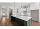 Bright kitchen featuring a spacious island with quartz countertop, white cabinets, and stainless steel appliances at 250 Pilot Ridge Rd, Zebulon, NC 27597