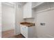 Bright laundry room with butcher block countertop and white cabinets at 250 Pilot Ridge Rd, Zebulon, NC 27597