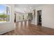 Open-concept living space with hardwood floors, fireplace, staircase, and seamless flow into the kitchen at 250 Pilot Ridge Rd, Zebulon, NC 27597