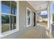 Cozy porch with wood flooring and large windows offers a peaceful outdoor space, enhancing the home's charm at 250 Pilot Ridge Rd, Zebulon, NC 27597