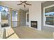Inviting screened-in porch with a fireplace, wood ceiling fan, and a beautiful view at 250 Pilot Ridge Rd, Zebulon, NC 27597