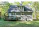 View of the back exterior featuring a wood deck and spacious, green yard at 2700 Ross Rd, Durham, NC 27703