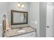 Bathroom featuring a decorative mirror and granite countertop at 2700 Ross Rd, Durham, NC 27703