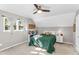 Cozy bedroom with natural light, dormered ceilings, and a modern ceiling fan at 2700 Ross Rd, Durham, NC 27703