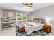 Cozy bedroom featuring a comfortable bed, a vanity, and a large window with natural light at 2700 Ross Rd, Durham, NC 27703