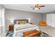 Comfortable bedroom featuring a ceiling fan, wood chest and blue accent rug at 2700 Ross Rd, Durham, NC 27703