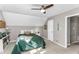 Bright bedroom with dormered ceilings, a ceiling fan, and neutral colored walls at 2700 Ross Rd, Durham, NC 27703