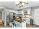 Well-lit kitchen showcasing white cabinets, stainless steel appliances, and a functional island at 2700 Ross Rd, Durham, NC 27703