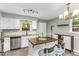 Modern kitchen featuring white cabinets, stainless steel appliances, and an island with seating at 2700 Ross Rd, Durham, NC 27703